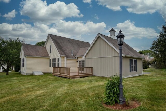 12 Braeburn Ln Unit 12, Ashland, MA 01721 - rear view of property with a deck, a yard, and a shingled roof