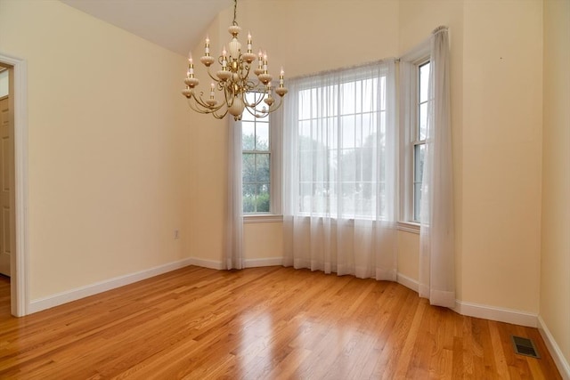 12 Braeburn Ln Unit 12, Ashland, MA 01721 - unfurnished room featuring wood finished floors, a chandelier, and vaulted ceiling