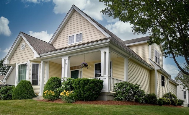 12 Braeburn Ln Unit 12, Ashland, MA 01721 - bungalow-style house with a porch, a shingled roof, and a front lawn