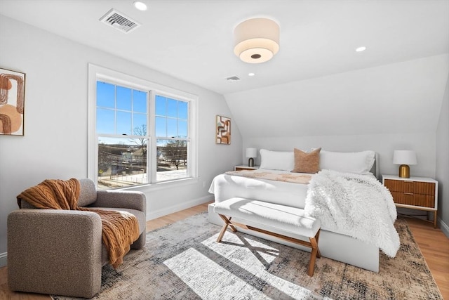 bedroom featuring hardwood / wood-style flooring and vaulted ceiling