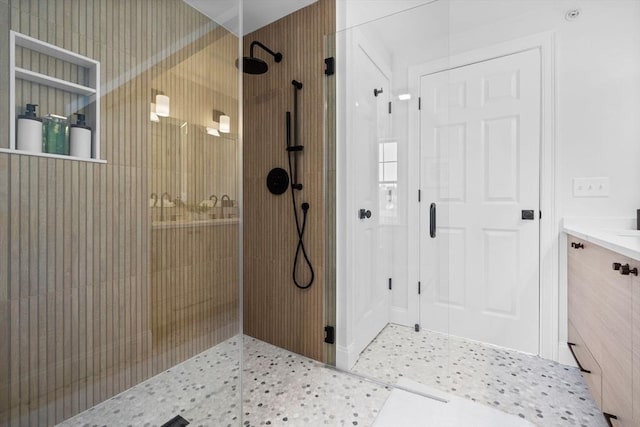 bathroom featuring vanity and a shower with door