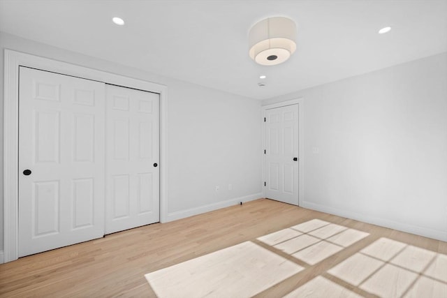 unfurnished bedroom featuring hardwood / wood-style flooring and a closet