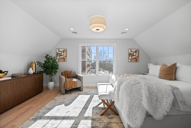 bedroom featuring lofted ceiling and light hardwood / wood-style floors