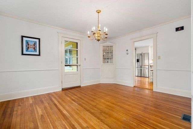 8 Warren Rd, Marblehead, MA 01945 - unfurnished dining area with a chandelier, light wood-type flooring, and ornamental molding