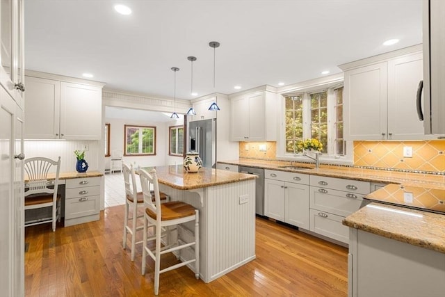8 Warren Rd, Marblehead, MA 01945 - kitchen featuring stainless steel appliances, light wood-type flooring, light stone counters, backsplash, and recessed lighting