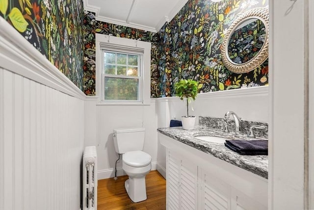 8 Warren Rd, Marblehead, MA 01945 - half bath with ornamental molding, wallpapered walls, toilet, vanity, and wood finished floors