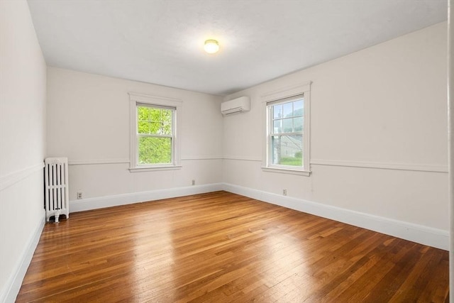 8 Warren Rd, Marblehead, MA 01945 - empty room featuring radiator, a wall mounted AC, wood-type flooring, and baseboards