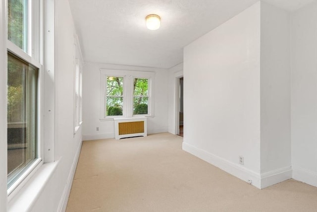 8 Warren Rd, Marblehead, MA 01945 - spare room with radiator heating unit, carpet flooring, and baseboards