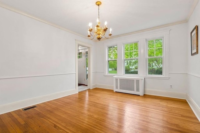 8 Warren Rd, Marblehead, MA 01945 - unfurnished room with radiator heating unit, a chandelier, light wood finished floors, and crown molding