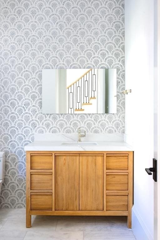 bathroom featuring vanity and toilet