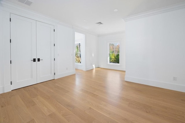 unfurnished bedroom with light hardwood / wood-style flooring and ornamental molding