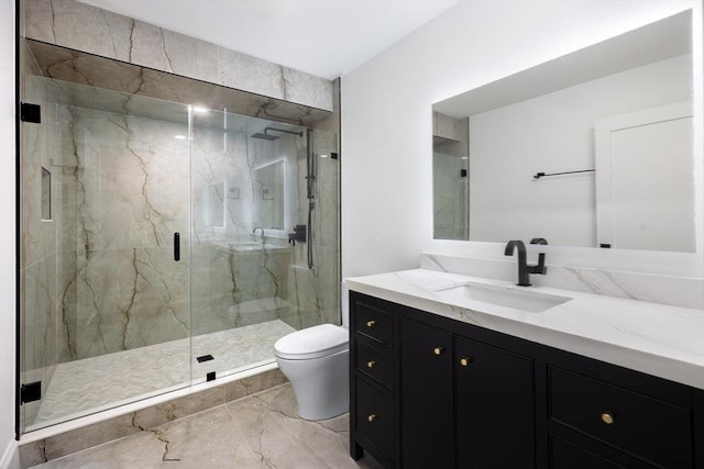 bathroom featuring a shower with door, vanity, and toilet