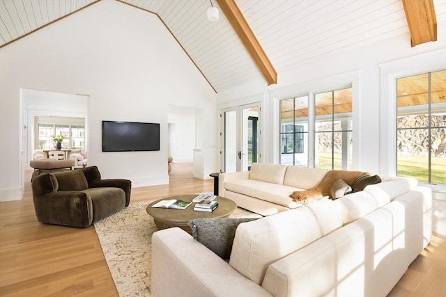 living room with beam ceiling, light wood-type flooring, and high vaulted ceiling