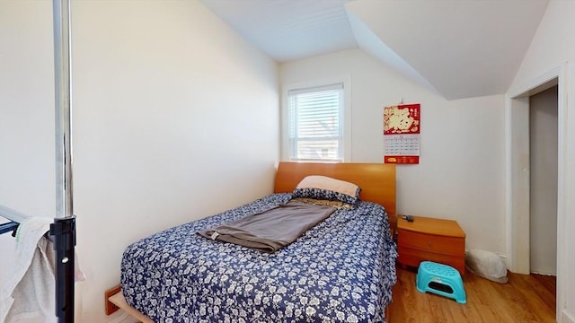 bedroom featuring wood-type flooring and lofted ceiling