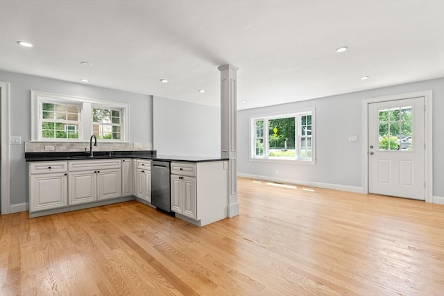 328 N Main St, Sharon, MA 02067 - kitchen with stainless steel dishwasher, light wood-style flooring, plenty of natural light, decorative columns, and recessed lighting