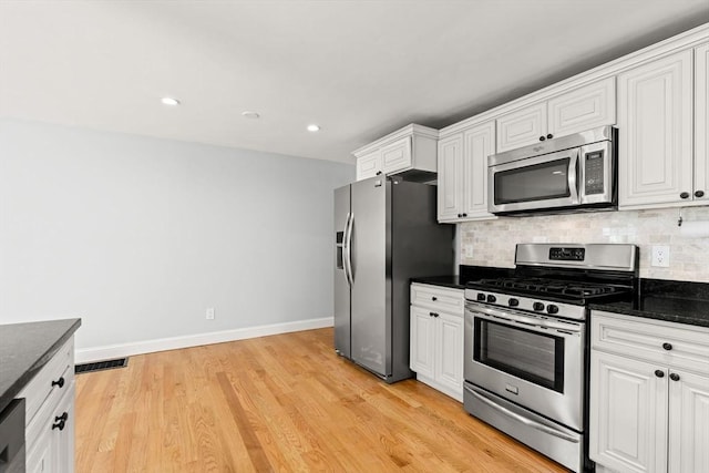328 N Main St, Sharon, MA 02067 - kitchen featuring stainless steel appliances, white cabinets, tasteful backsplash, light wood-style flooring, and recessed lighting