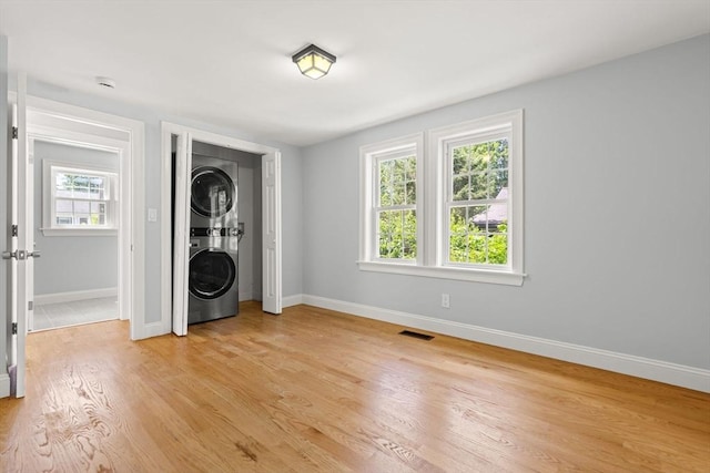 328 N Main St, Sharon, MA 02067 - washroom with stacked washer / dryer and light wood-style flooring