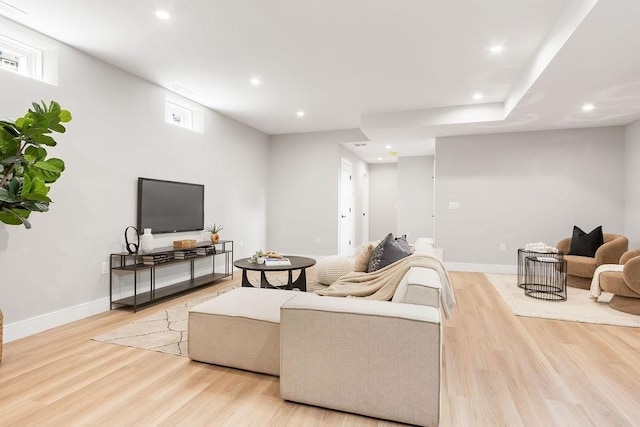 living room with recessed lighting, light wood-type flooring, and baseboards