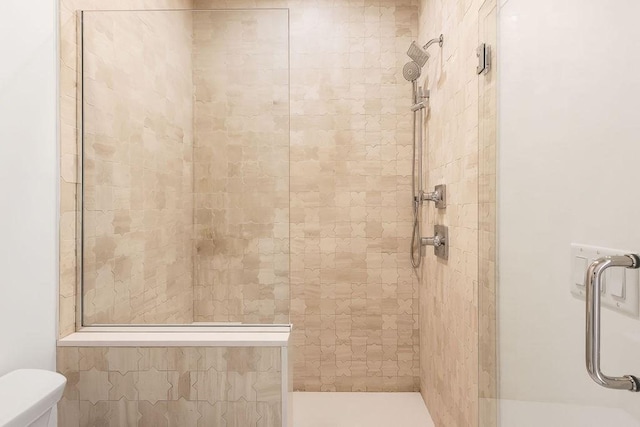 full bathroom with toilet and tiled shower