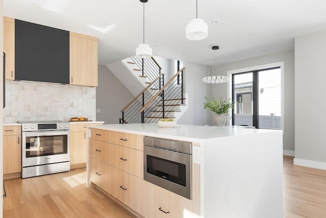 kitchen featuring light wood-type flooring, stainless steel range with electric cooktop, built in microwave, and light brown cabinetry