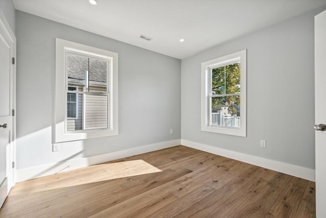 unfurnished room with light hardwood / wood-style flooring