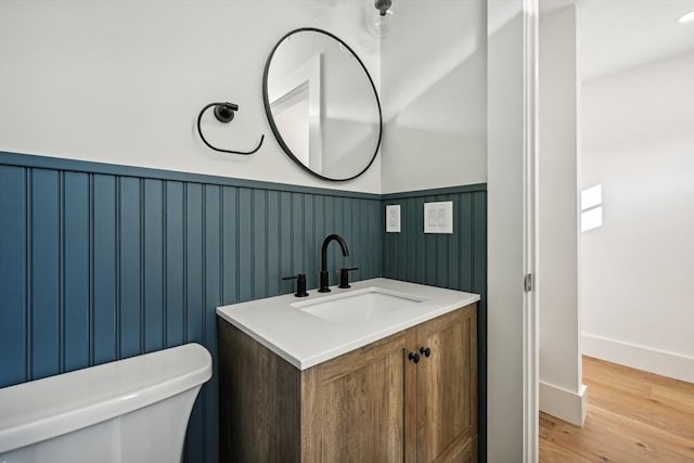 bathroom with vanity, hardwood / wood-style floors, and toilet