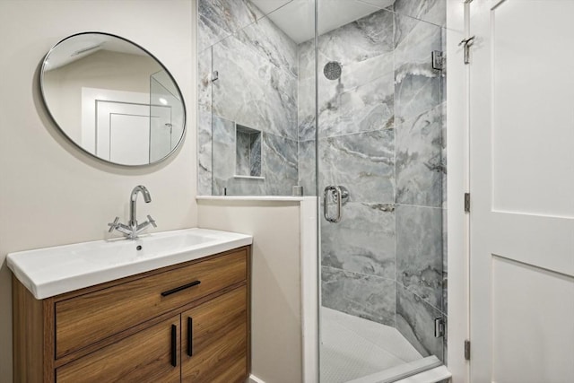 bathroom with vanity and a shower with shower door