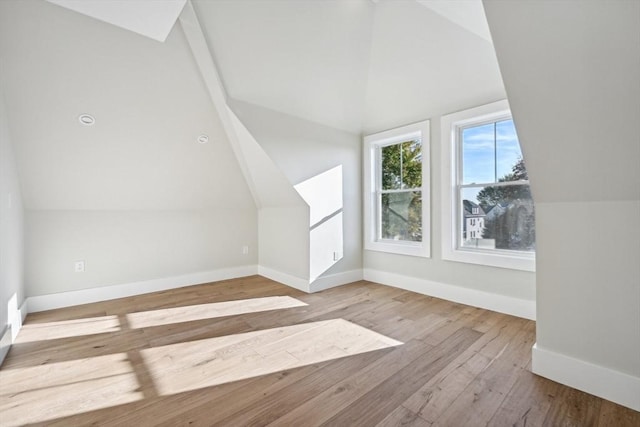 bonus room featuring vaulted ceiling and light hardwood / wood-style floors