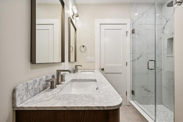 bathroom with a shower with door and vanity