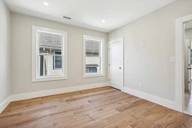 unfurnished room with light wood-type flooring