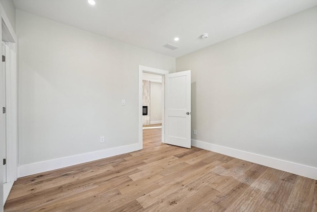 unfurnished room with light hardwood / wood-style flooring