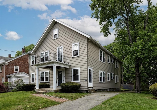 17-19 Maple St, Newton, MA 02466 - view of front of house featuring a balcony and a front lawn