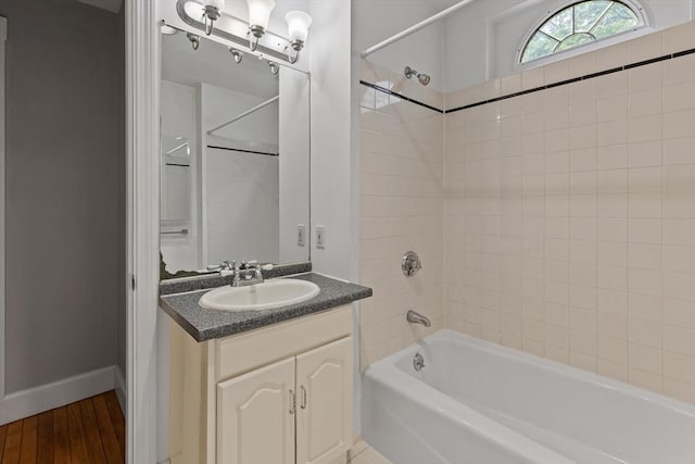 17-19 Maple St, Newton, MA 02466 - bathroom featuring vanity, bathing tub / shower combination, wood finished floors, and baseboards