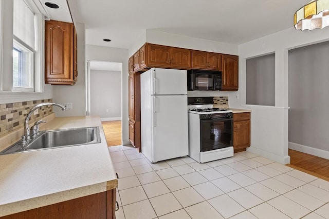 17-19 Maple St, Newton, MA 02466 - kitchen featuring white appliances, backsplash, a sink, and light countertops