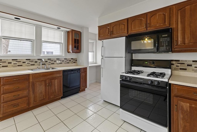 17-19 Maple St, Newton, MA 02466 - kitchen featuring black appliances, a sink, backsplash, light countertops, and light tile patterned floors