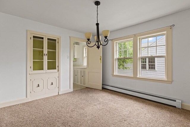 17-19 Maple St, Newton, MA 02466 - carpeted empty room with a baseboard heating unit and a chandelier