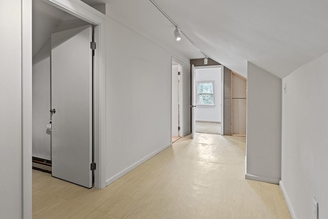 17-19 Maple St, Newton, MA 02466 - hallway with light floors, rail lighting, vaulted ceiling, and baseboards