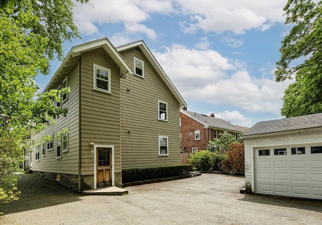 17-19 Maple St, Newton, MA 02466 - view of property exterior featuring a garage and asphalt driveway