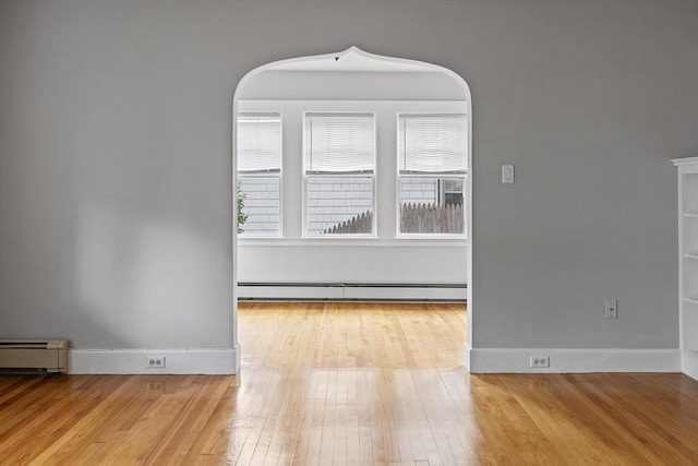 17-19 Maple St, Newton, MA 02466 - spare room featuring a baseboard heating unit, wood-type flooring, and baseboards