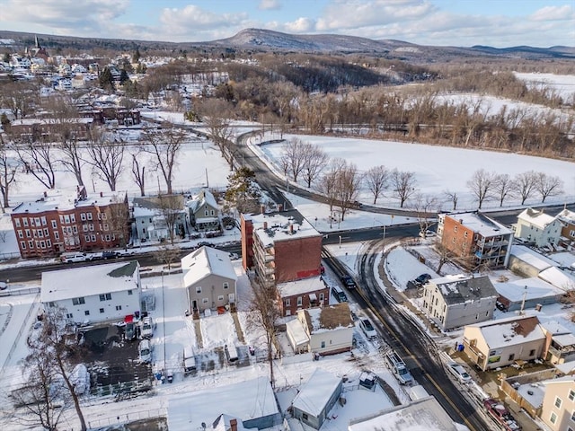 snowy aerial view with a mountain view