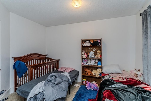 carpeted bedroom featuring a textured ceiling