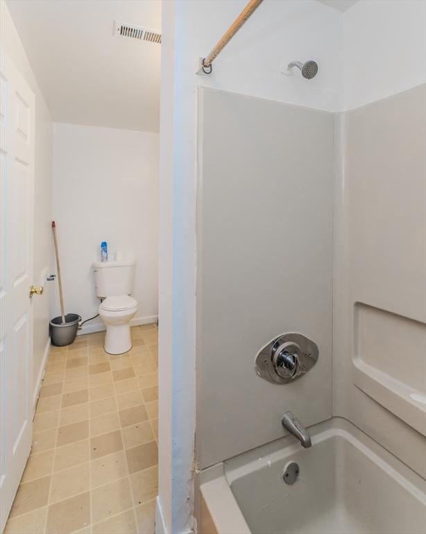 bathroom with tub / shower combination and toilet