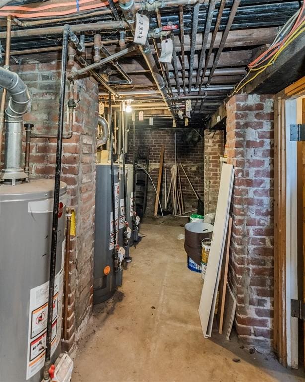 basement with gas water heater and brick wall