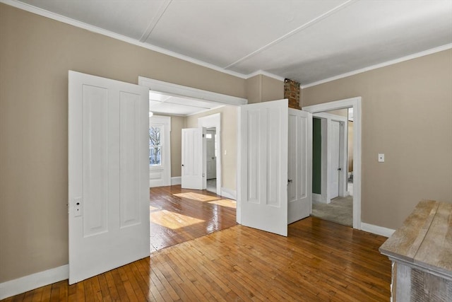 unfurnished room with wood-type flooring and ornamental molding