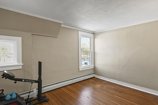 workout room with dark wood-type flooring, a baseboard radiator, and ornamental molding