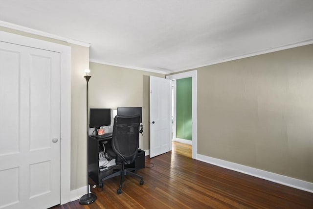 home office with dark wood-type flooring and ornamental molding