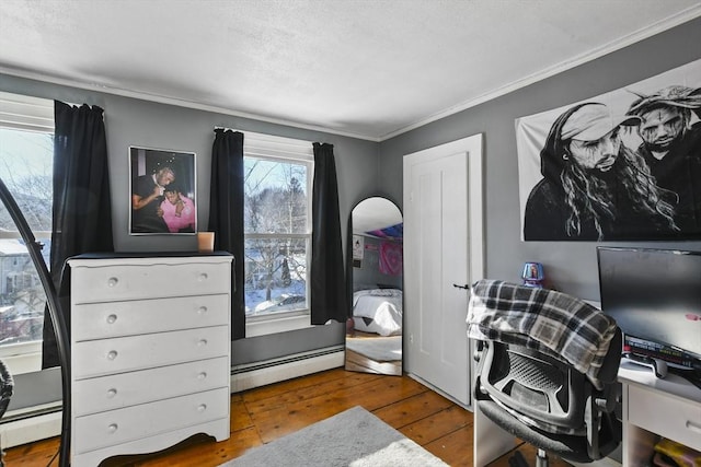 office with crown molding, a baseboard radiator, and wood-type flooring