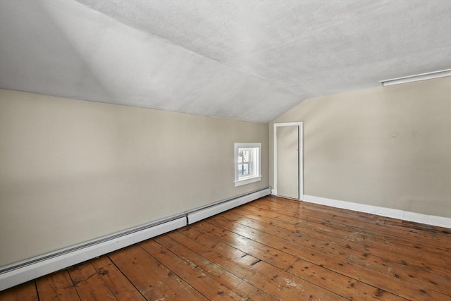 bonus room with lofted ceiling, hardwood / wood-style floors, a textured ceiling, and baseboard heating