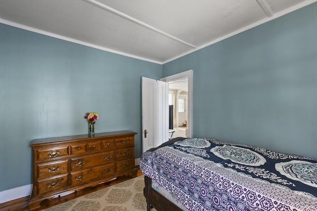 bedroom with crown molding and light wood-type flooring