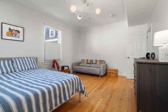 bedroom featuring wood-type flooring, a notable chandelier, and crown molding